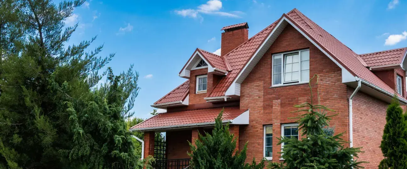 Same brick home with new tile roof — after carrier supplement and replacement