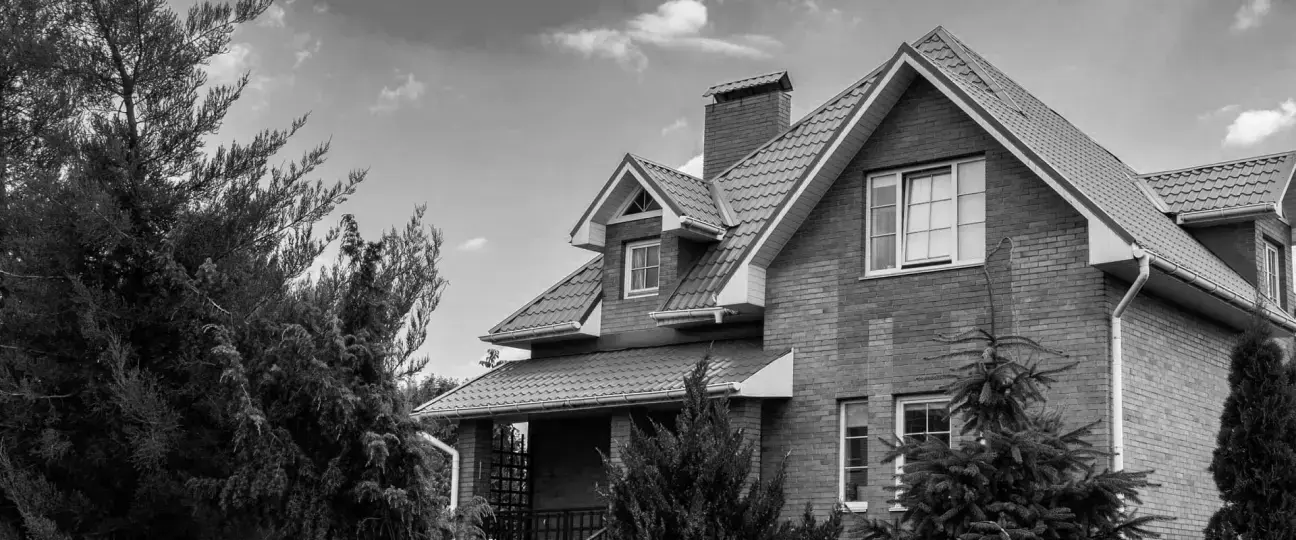 Brick home with damaged roof — before claim resolution